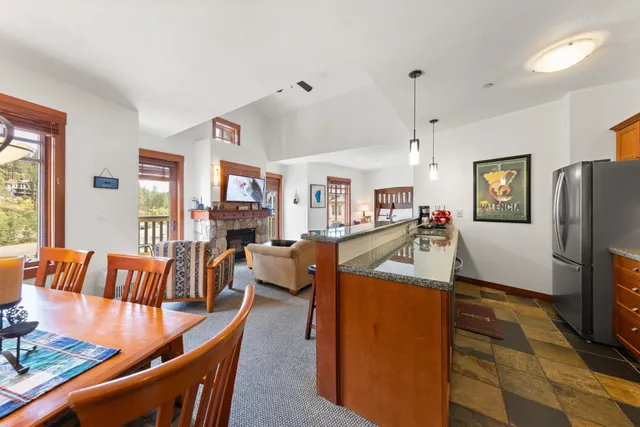 a kitchen with stainless steel appliances granite countertop a refrigerator and a stove