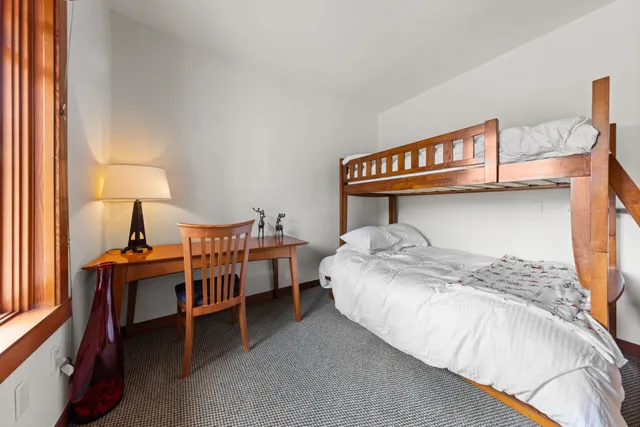 a bedroom with a bed and a lamp on table