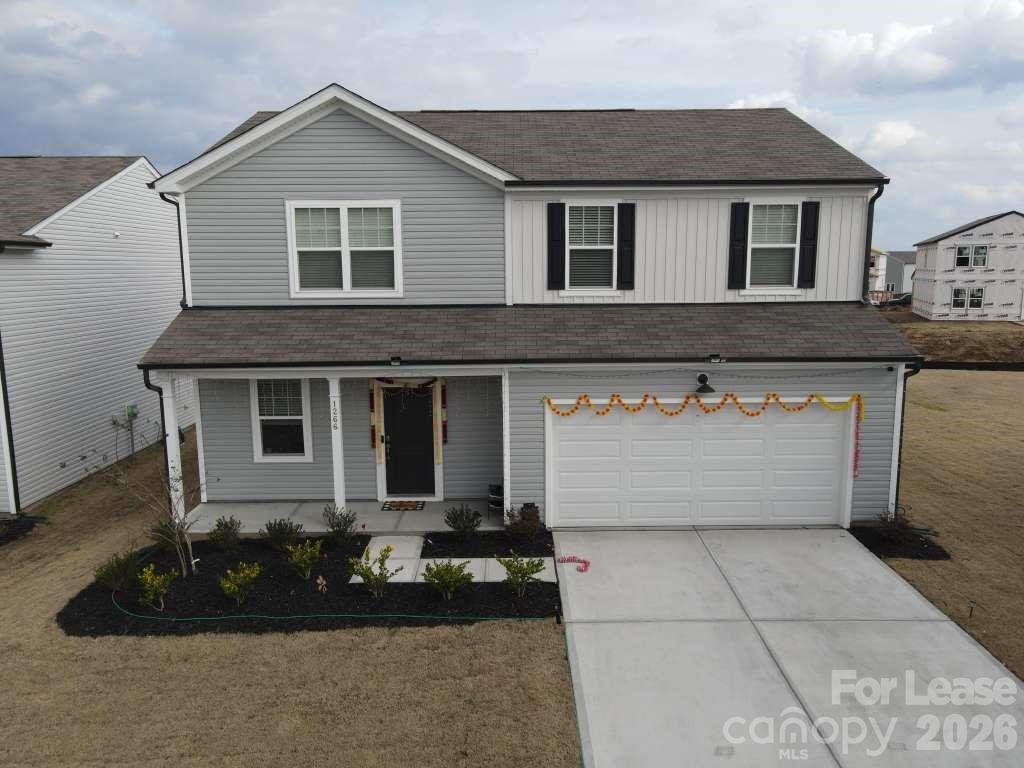 a front view of house with garage and yard