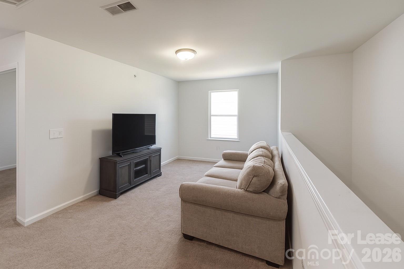 1266 Nesters Store Place Southwest Concord, NC 28027 - Photo 13 of 30 a living room with furniture and a flat screen tv