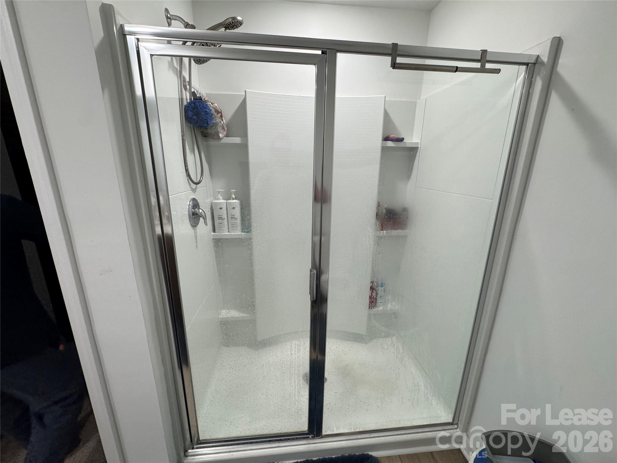 1266 Nesters Store Place Southwest Concord, NC 28027 - Photo 16 of 30 a bathroom with a glass door shower and sink