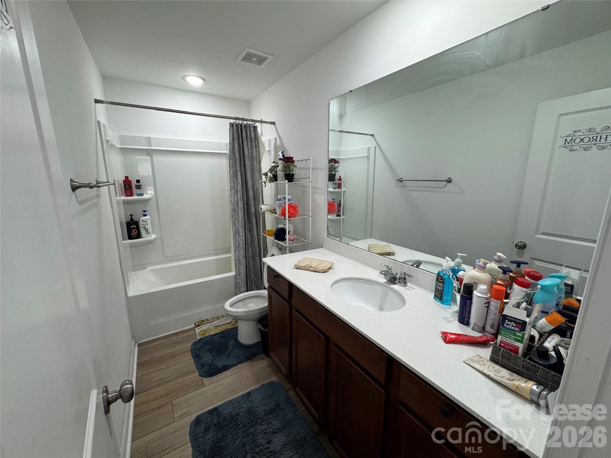 1266 Nesters Store Place Southwest Concord, NC 28027 - Photo 20 of 30 a bathroom with a sink mirror vanity and toilet