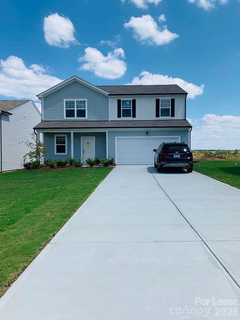 1266 Nesters Store Place Southwest Concord, NC 28027 - Photo 2 of 30 a car parked in front of house with a yard