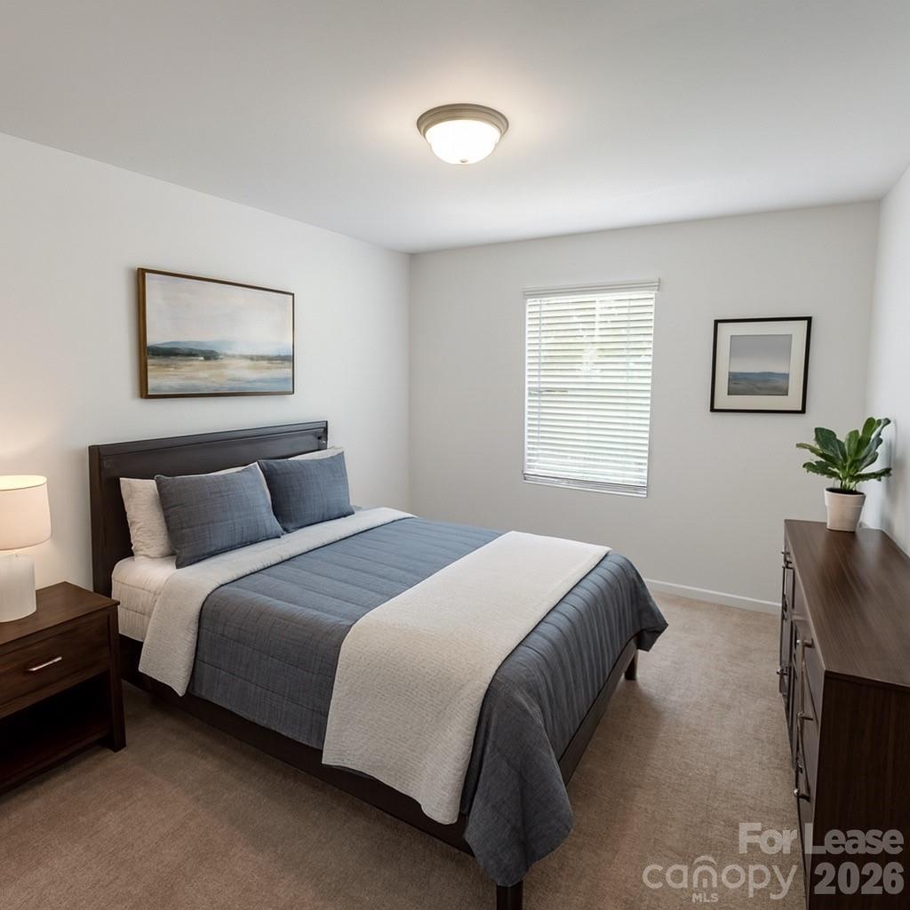 1266 Nesters Store Place Southwest Concord, NC 28027 - Photo 21 of 30 a bedroom with bed and a potted plant
