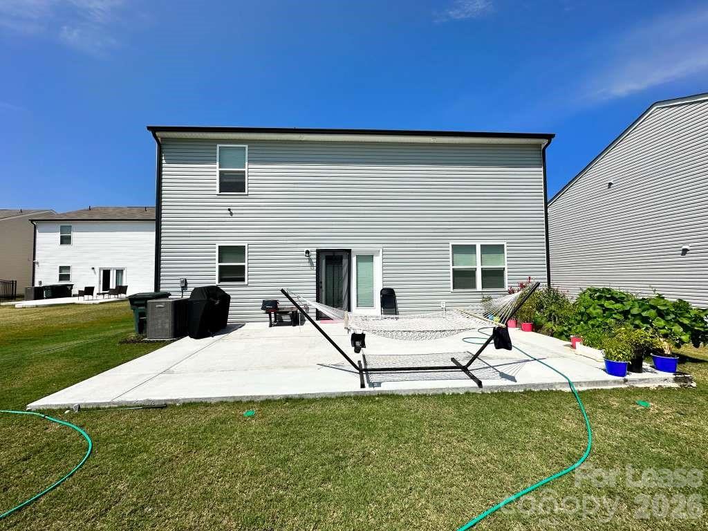 1266 Nesters Store Place Southwest Concord, NC 28027 - Photo 23 of 30 a view of a house with a backyard and porch