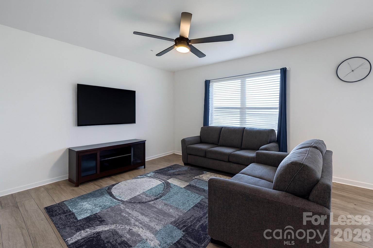 1266 Nesters Store Place Southwest Concord, NC 28027 - Photo 7 of 30 a living room with furniture a flat screen tv and a fireplace