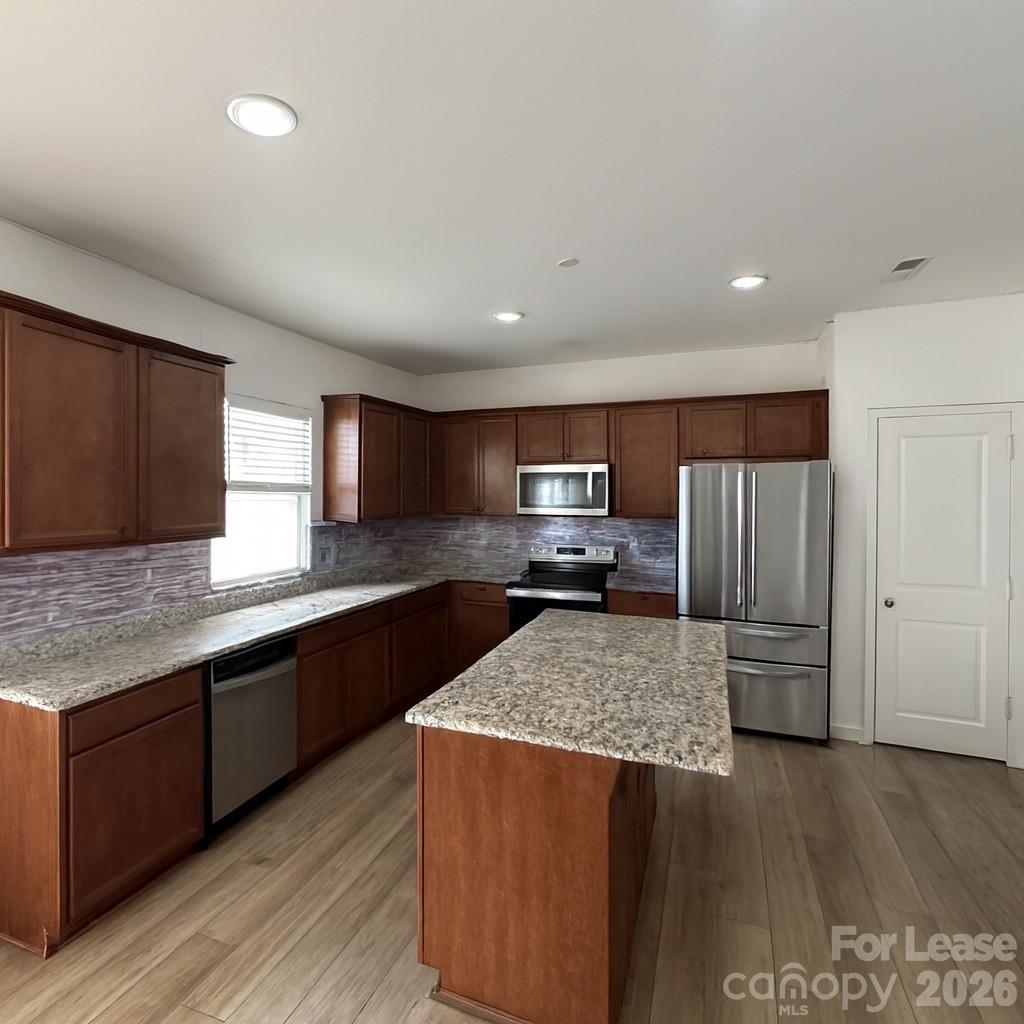 1266 Nesters Store Place Southwest Concord, NC 28027 - Photo 9 of 30 a kitchen with stainless steel appliances granite countertop a sink counter space and cabinets