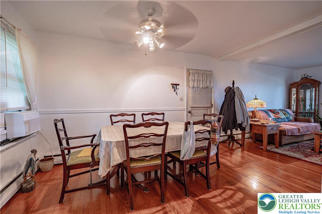 7562 Quarry Road Macungie, PA 18062 - Photo 13 of 35 a view of a dining room with furniture and wooden floor