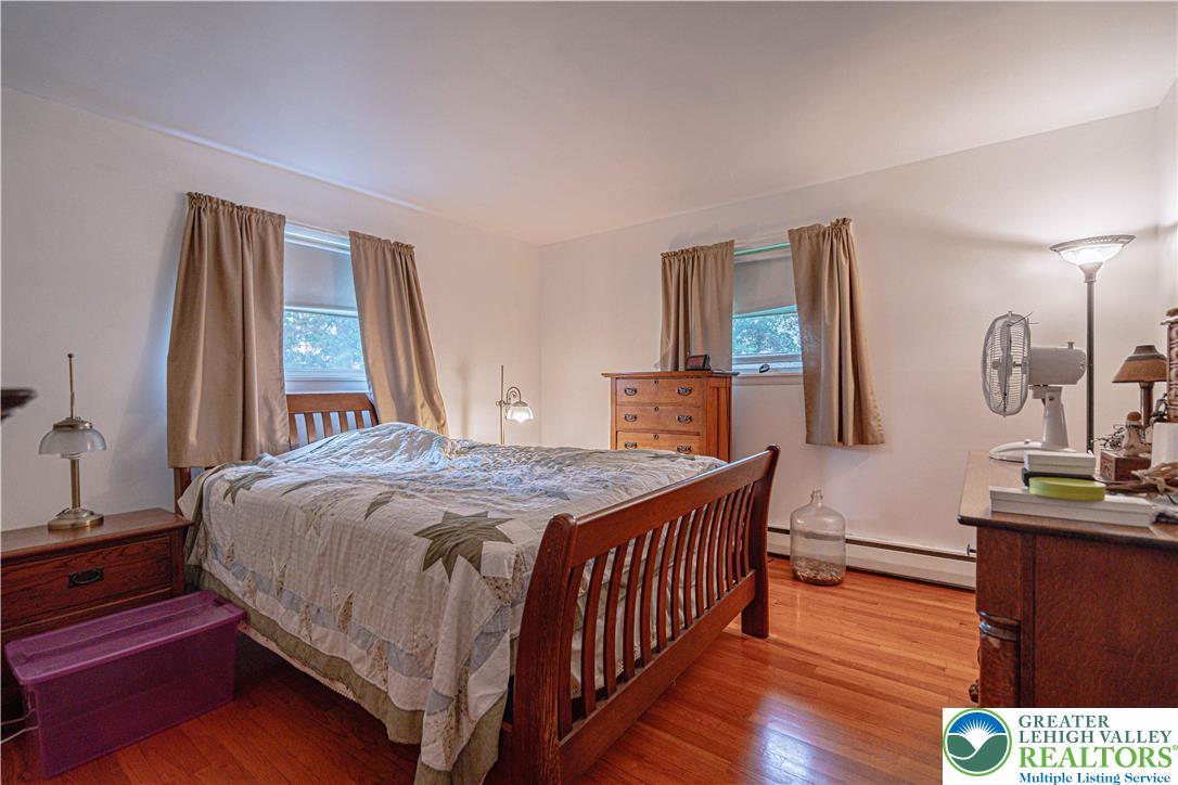 7562 Quarry Road Macungie, PA 18062 - Photo 18 of 35 a bedroom with a bed and wooden floor