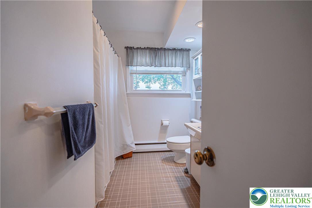 7562 Quarry Road Macungie, PA 18062 - Photo 21 of 35 a bathroom with a sink a toilet and shower