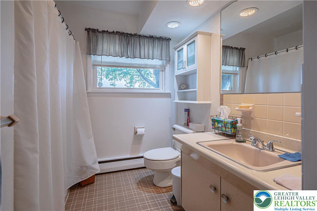 7562 Quarry Road Macungie, PA 18062 - Photo 22 of 35 a bathroom with a sink toilet and a mirror