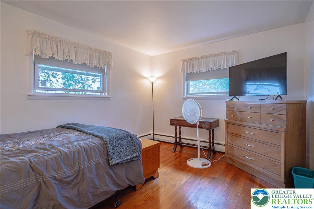 7562 Quarry Road Macungie, PA 18062 - Photo 23 of 35 a bedroom with a bed and flat screen tv