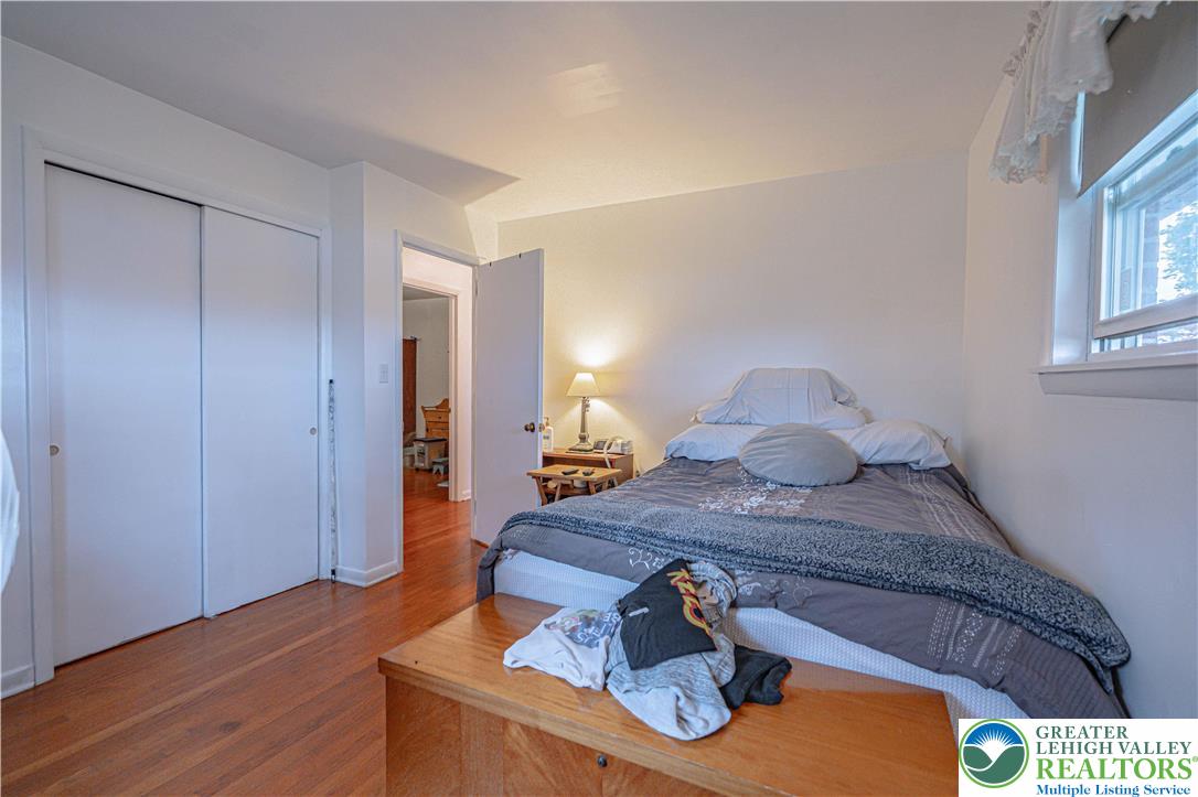 7562 Quarry Road Macungie, PA 18062 - Photo 24 of 35 a bedroom with a bed and wooden floor