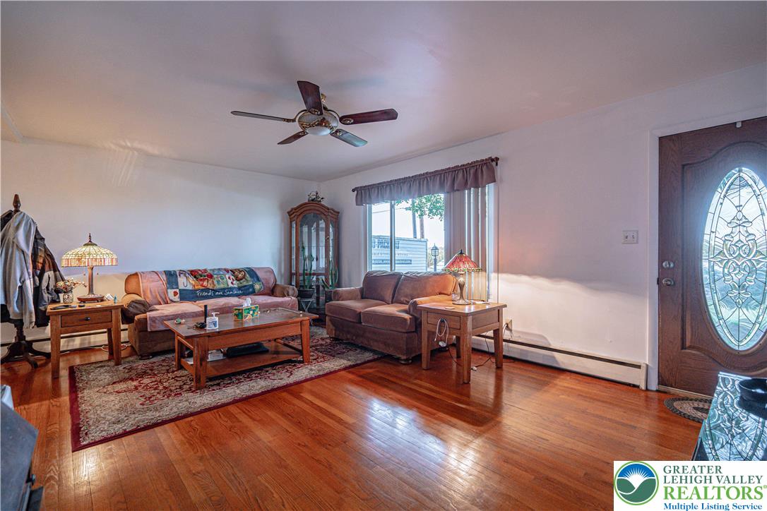 7562 Quarry Road Macungie, PA 18062 - Photo 9 of 35 a living room with furniture and a flat screen tv