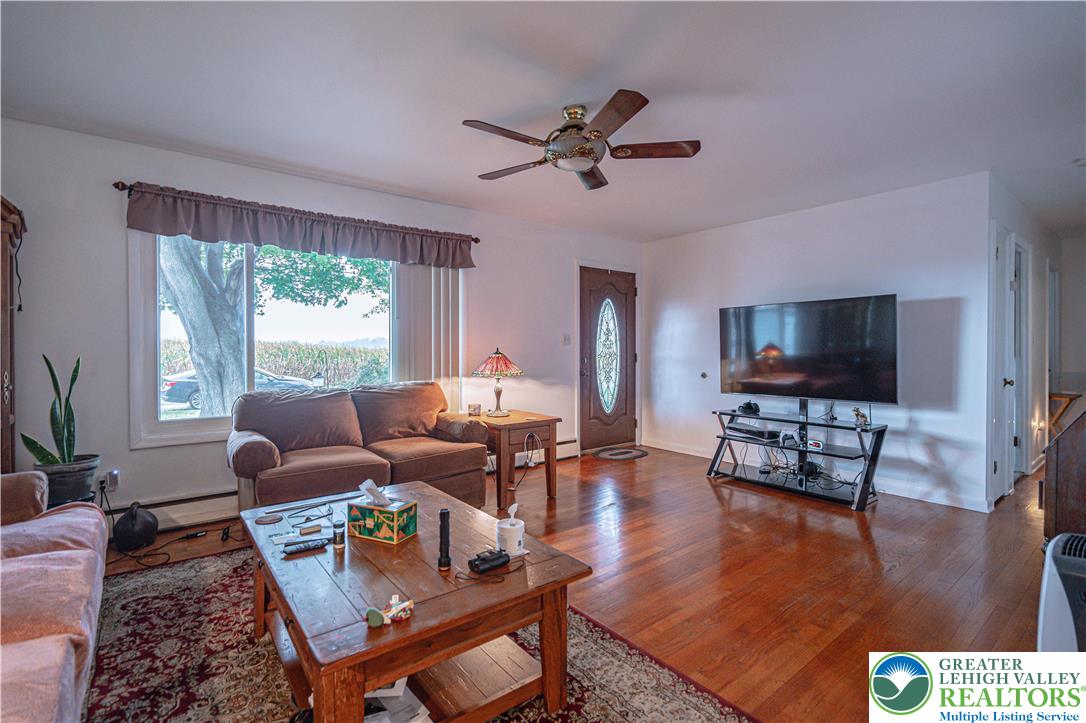 7562 Quarry Road Macungie, PA 18062 - Photo 10 of 35 a living room with furniture and a flat screen tv