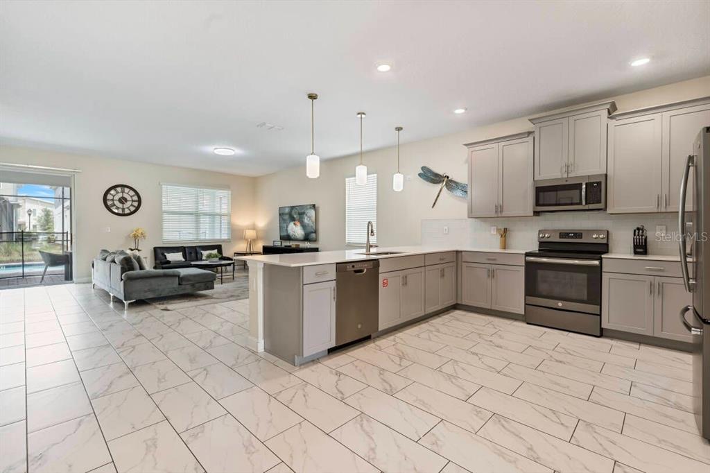 4541 Target Boulevard Kissimmee, FL 34746 - Photo 15 of 33 a kitchen with stainless steel appliances a refrigerator sink and microwave