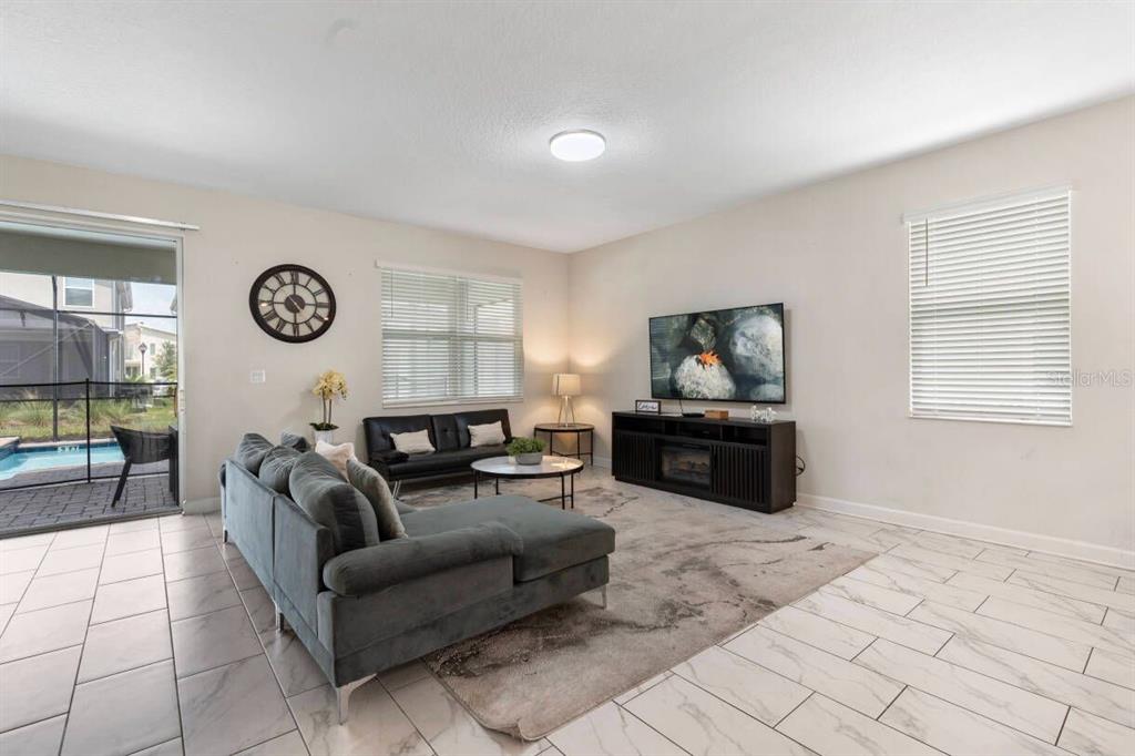 4541 Target Boulevard Kissimmee, FL 34746 - Photo 18 of 33 a living room with furniture and a flat screen tv