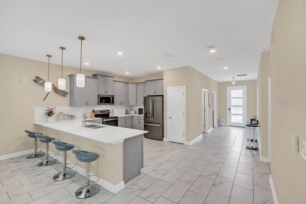 4541 Target Boulevard Kissimmee, FL 34746 - Photo 19 of 33 a large kitchen with a large counter top appliances and cabinets