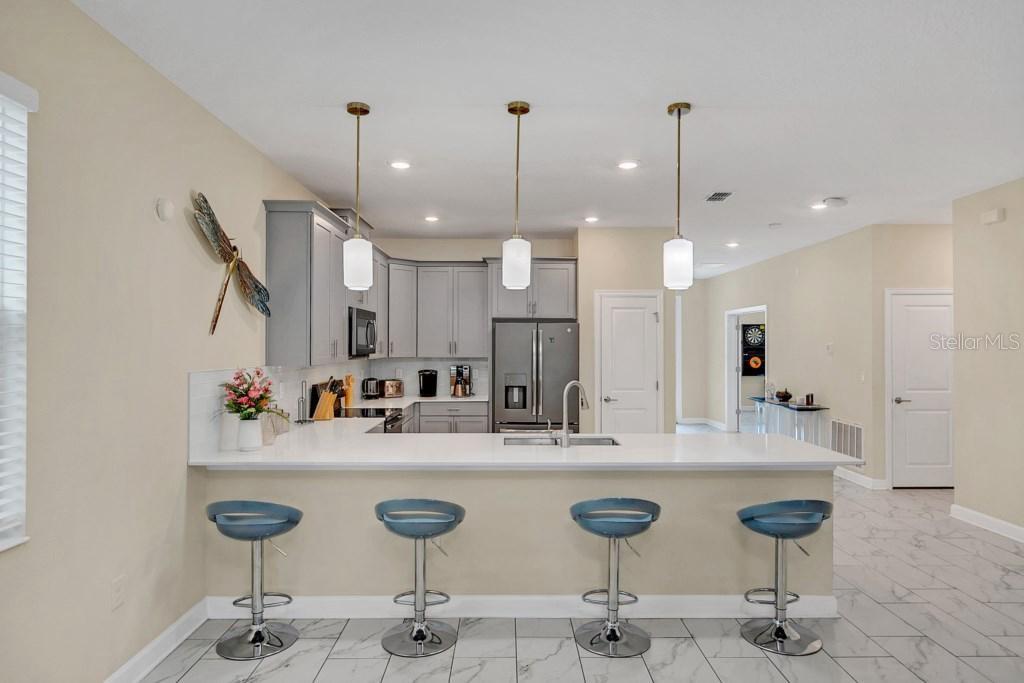 4541 Target Boulevard Kissimmee, FL 34746 - Photo 20 of 33 a bathroom with a granite countertop sink and a mirror