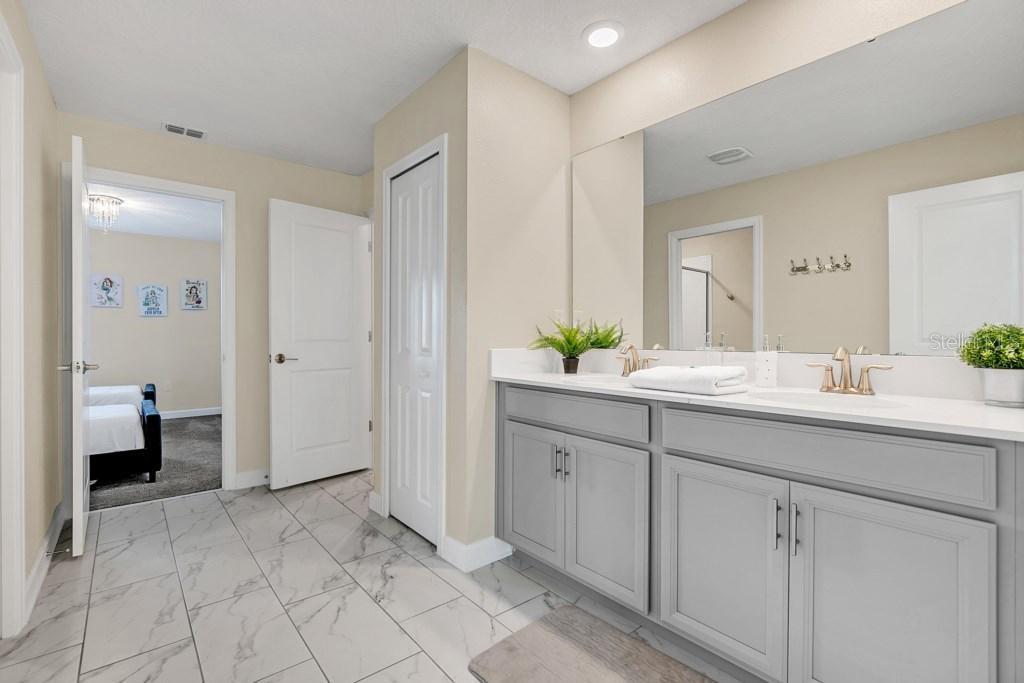 4541 Target Boulevard Kissimmee, FL 34746 - Photo 28 of 33 a spacious bathroom with a granite countertop sink a toilet and shower