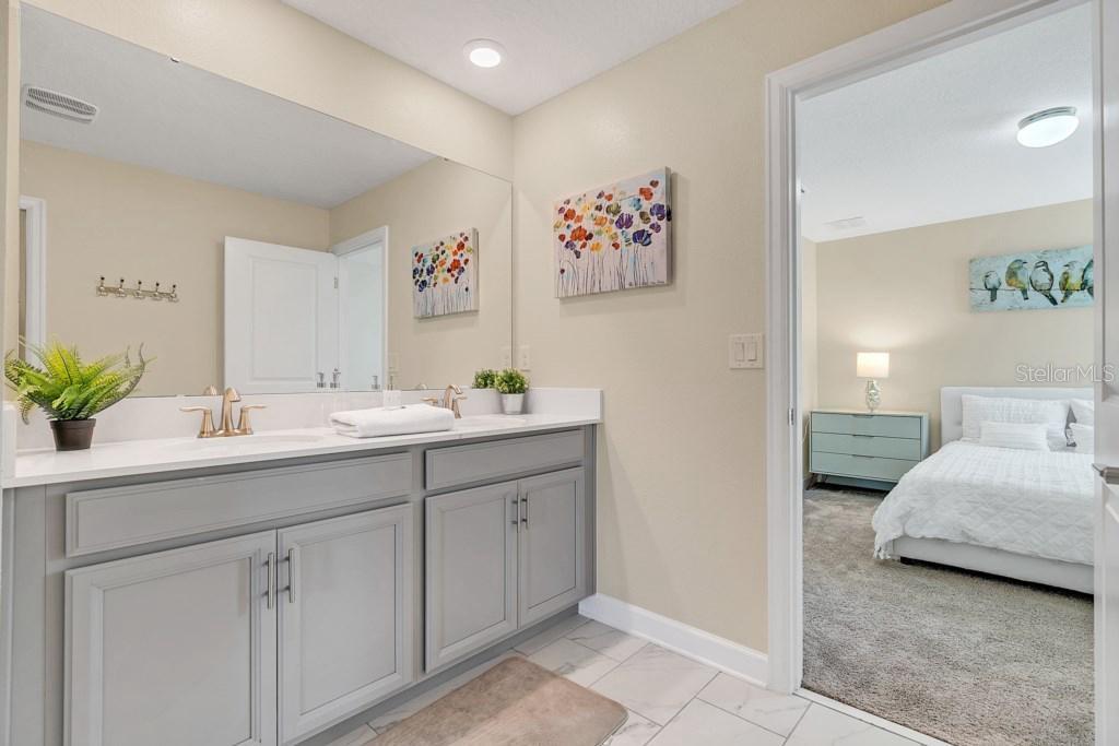 4541 Target Boulevard Kissimmee, FL 34746 - Photo 29 of 33 a en suite bathroom with a double vanity sink and a mirror