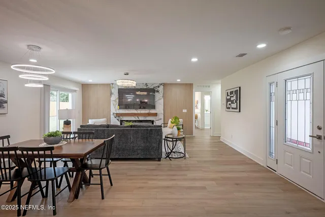 a kitchen with granite countertop kitchen island stainless steel appliances a dining table and chairs