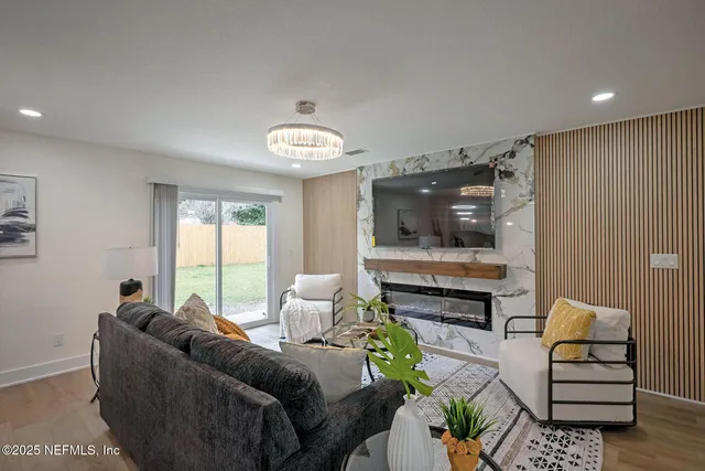 a living room with furniture and a chandelier