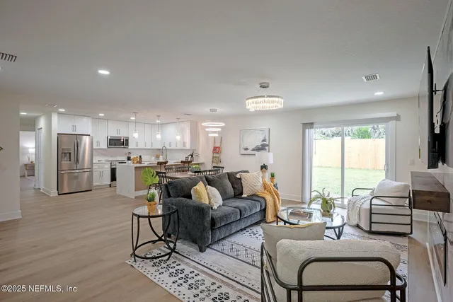a view of a hallway with bathroom and wooden floor