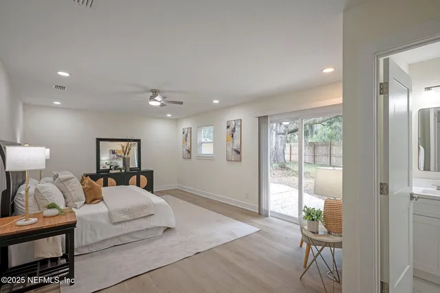 a bedroom with a large bed and a chandelier