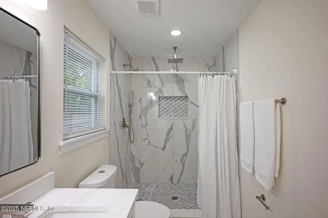 a bathroom with a double vanity sink and mirror