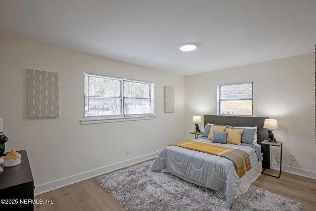 a bathroom with a shower curtain a sink and a toilet