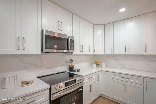 a kitchen with cabinets appliances and a sink