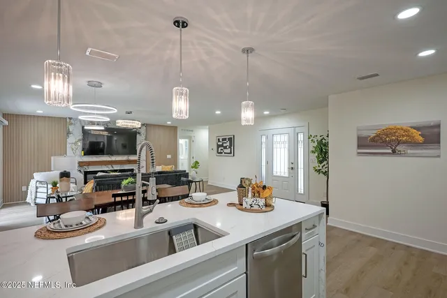 a kitchen with stainless steel appliances granite countertop a refrigerator and a stove top oven