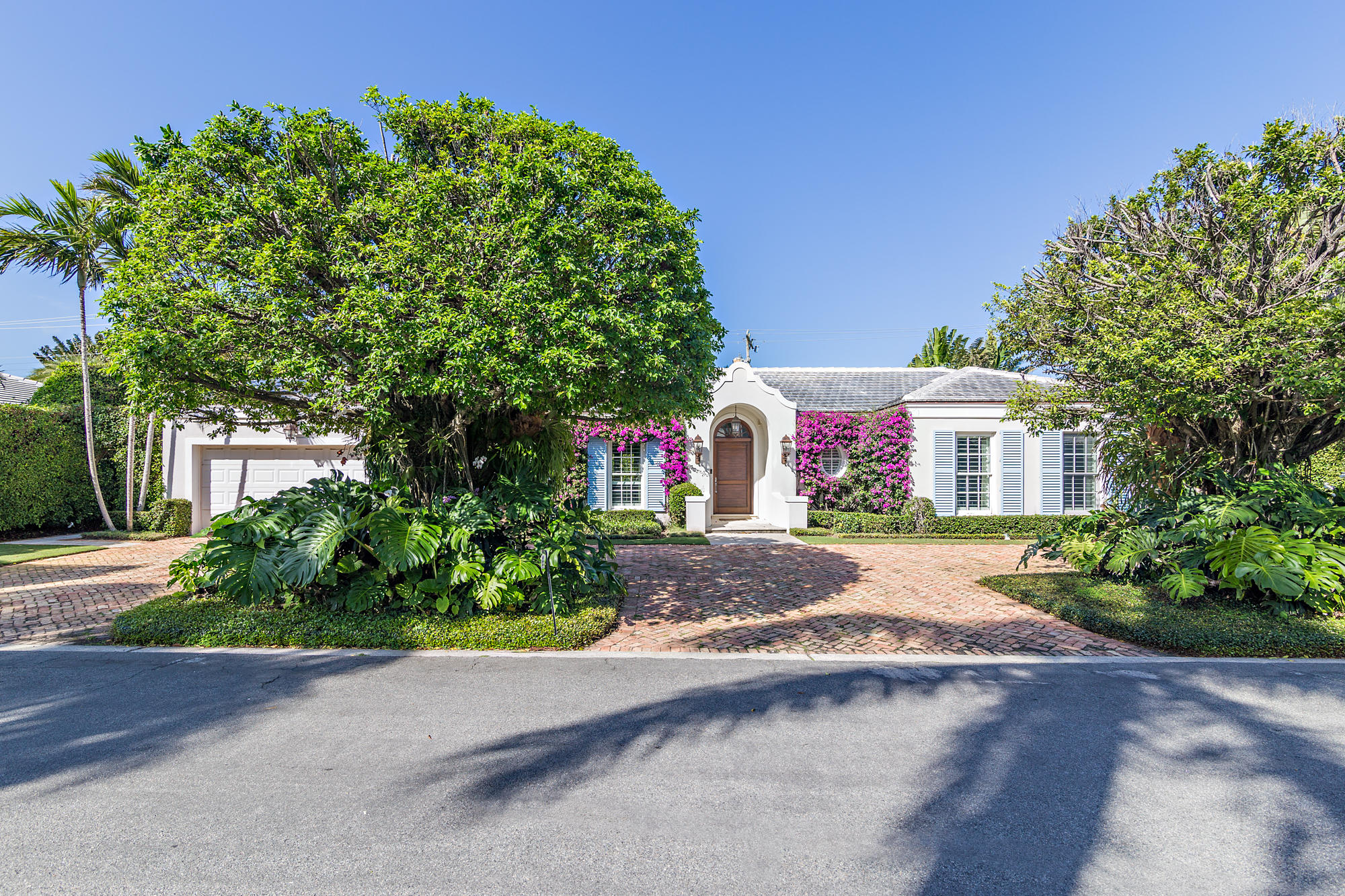 a front view of a house with a yard and a garage