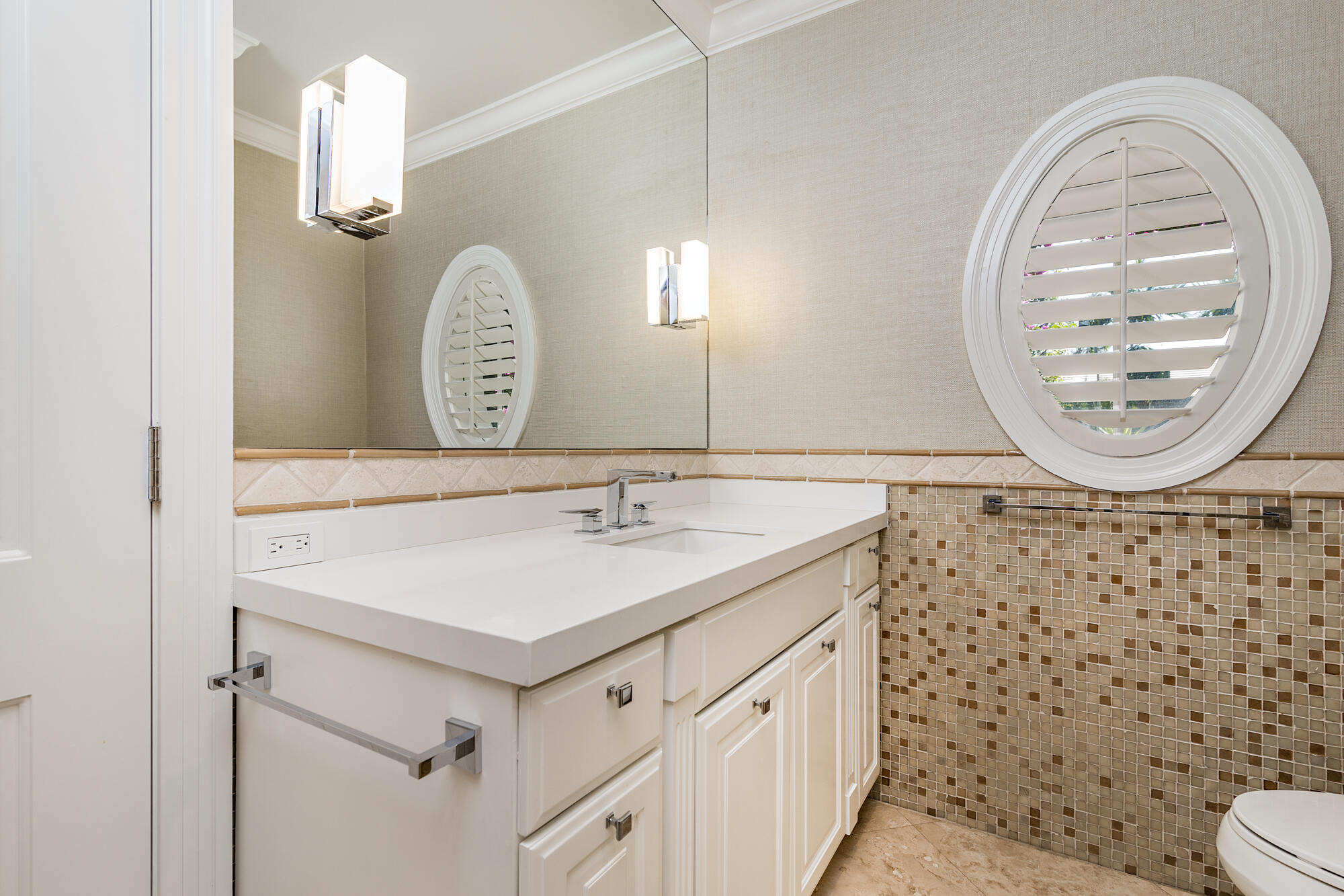 273 List Road Palm Beach, FL 33480 - Photo 15 of 26 a bathroom with a sink a toilet and a mirror