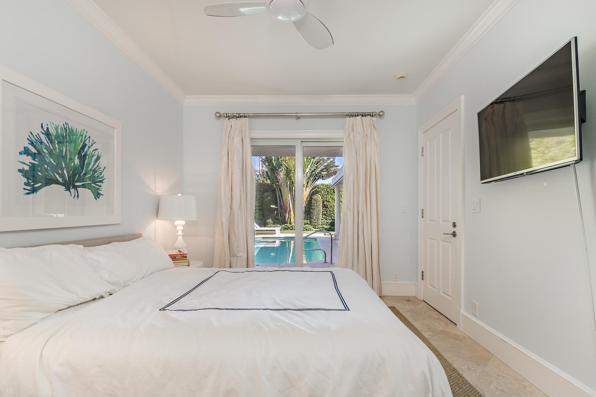 273 List Road Palm Beach, FL 33480 - Photo 16 of 26 a bedroom with a bed and a large window