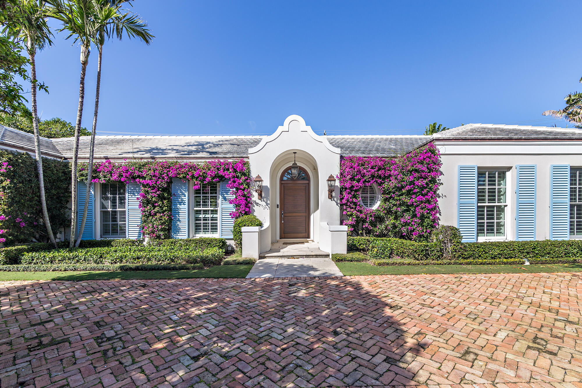 273 List Road Palm Beach, FL 33480 - Photo 2 of 26 a front view of a house with a garden