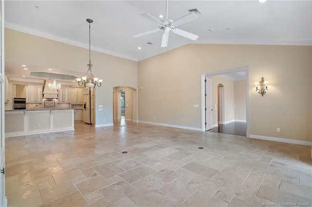 a view of a kitchen with a chandelier fan and refrigerator