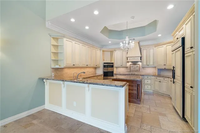 a kitchen with stainless steel appliances a sink stove and cabinets