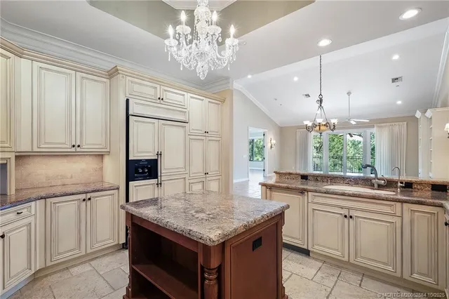 a kitchen with kitchen island granite countertop a sink center island and cabinets