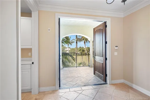 a view of a hallway to a livingroom and a livingroom