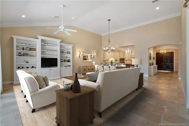 a living room with furniture fireplace and a chandelier