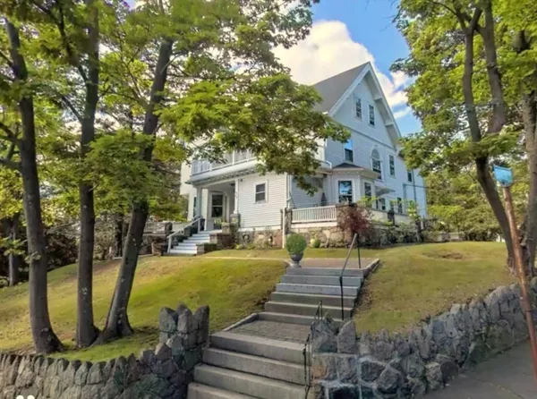 a view of a house with backyard porch and sitting area