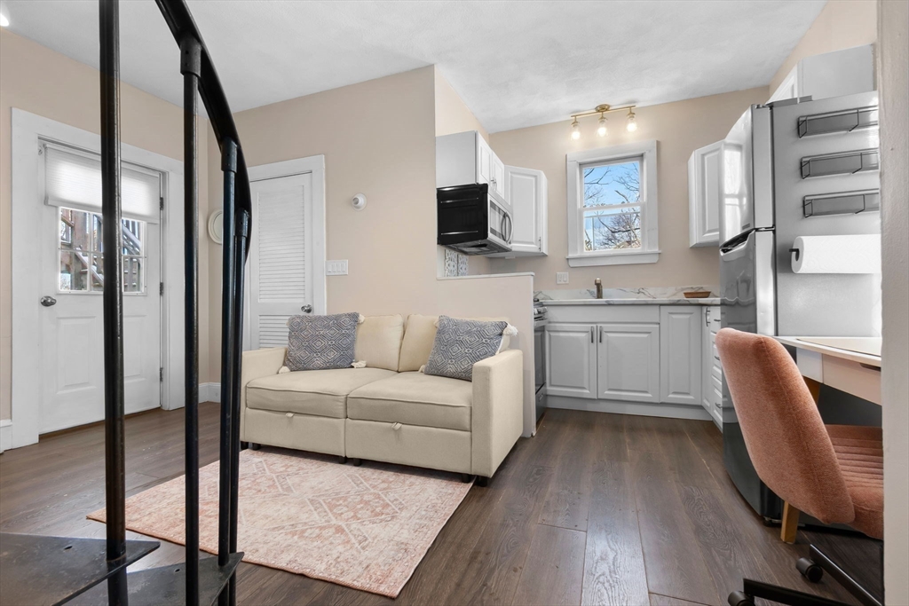 28 Columbus Avenue, Unit 4 Beverly, MA 01915 - Photo 12 of 25 a living room with furniture a flat screen tv and wooden floor