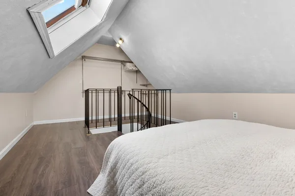 a bedroom with a bed and a chandelier