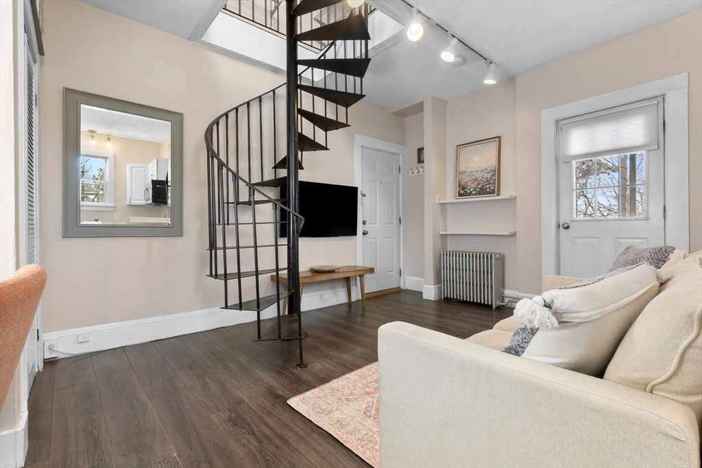 28 Columbus Avenue, Unit 4 Beverly, MA 01915 - Photo 5 of 25 a living room with furniture a fireplace and a flat screen tv
