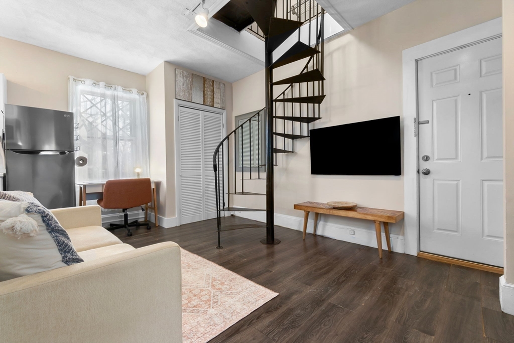 28 Columbus Avenue, Unit 4 Beverly, MA 01915 - Photo 6 of 25 a living room with furniture and a flat screen tv