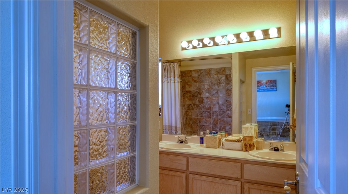 3704 North Campbell Road Las Vegas, NV 89129 - Photo 27 of 38 Double vanity with ample counter space and glass block window for natural light.