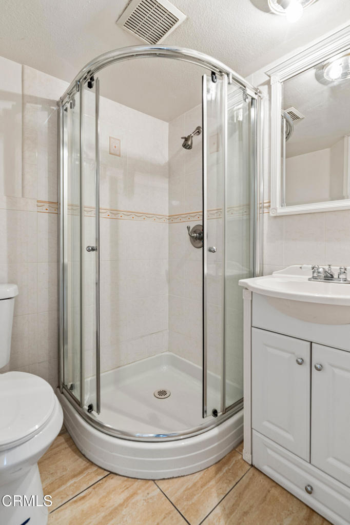 907 West Mission Road, Unit B Alhambra, CA 91801 - Photo 12 of 27 a bathroom with a shower a toilet and a sink