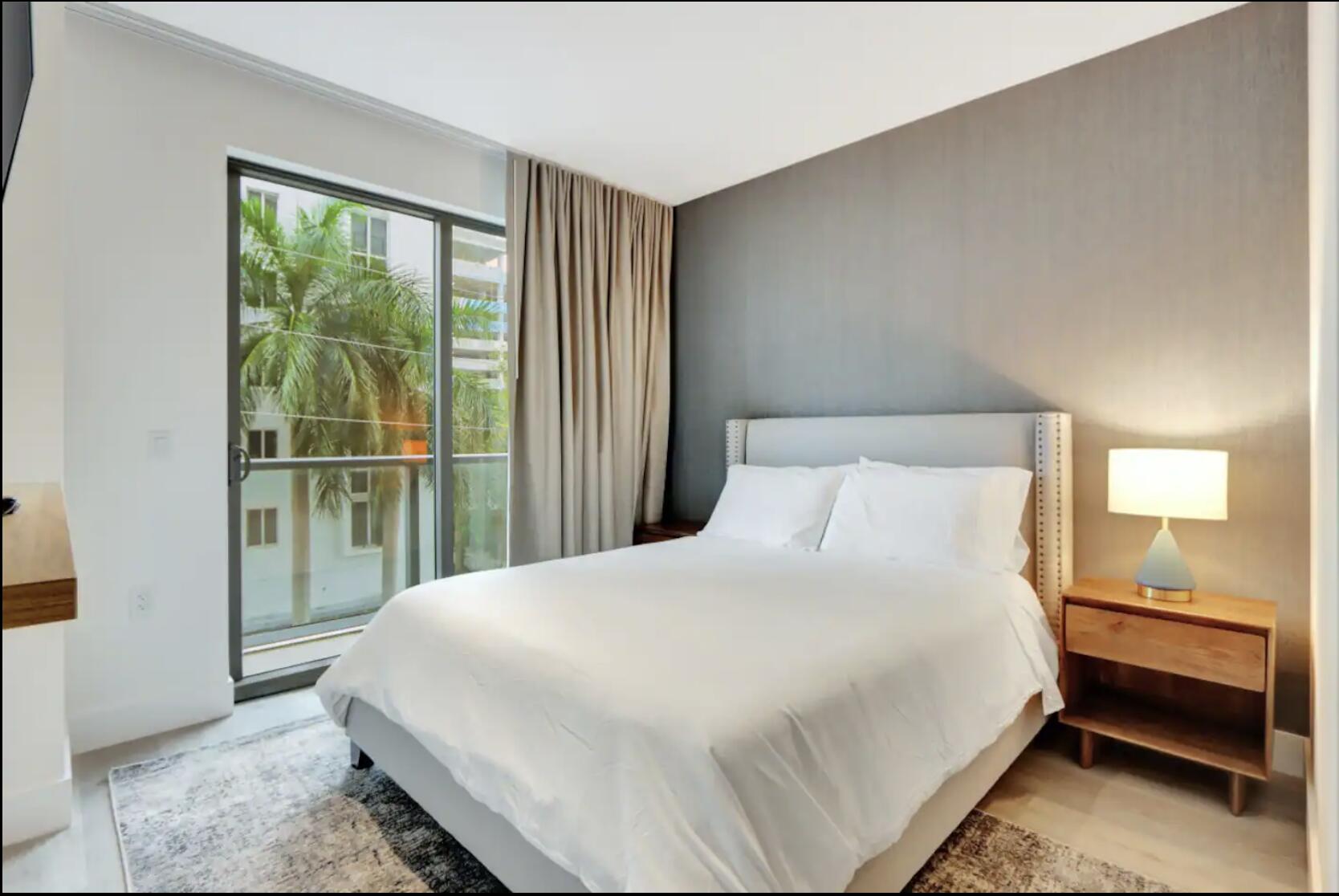 229 Southwest 9th Street, Unit 201 Miami, FL 33130 - Photo 9 of 21 a bedroom with a bed and a large window